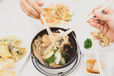 Close-up of hand holding food served on table