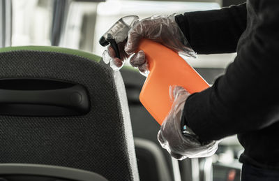 Midsection of man holding steering wheel