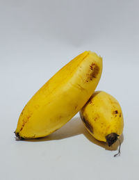 Close-up of yellow fruit against white background