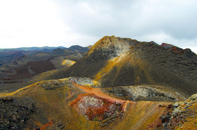 Aerial view of land and mountains against sky