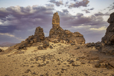 Rock formations on landscape against sky