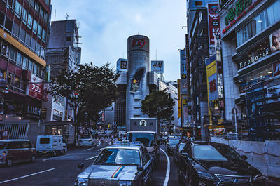 View of city street and buildings against sky