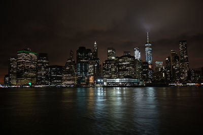 Illuminated buildings against sky at night