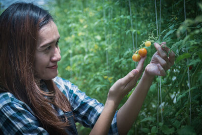 Close-up of young woman holding fruits