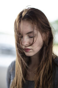 Close-up of young woman with tousled hair