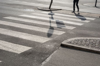 Low section of person crossing road