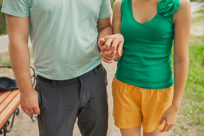 Midsection of couple standing outdoors