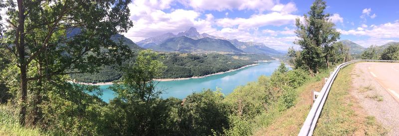 Panoramic view of trees and mountains against sky