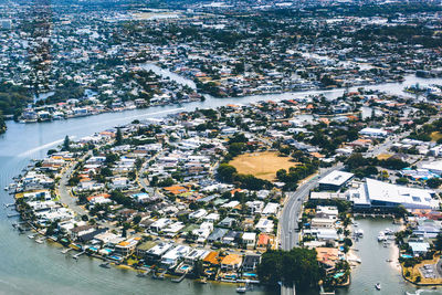 High angle view of town by sea against sky