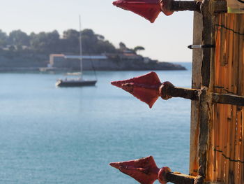 Close-up of red boat in sea against sky