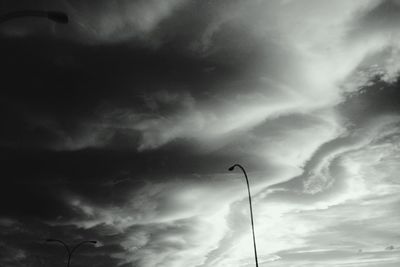 Low angle view of street light against cloudy sky