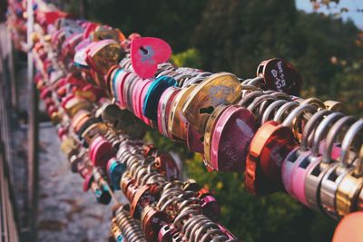 Close-up of love locks hanging on metal