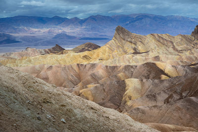 Scenic view of mountains against cloudy sky