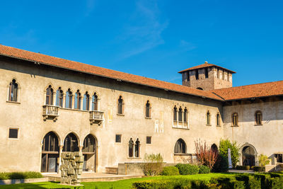 Low angle view of historic building against blue sky