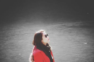 Close-up of woman wearing sunglasses against sea