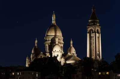 Low angle view of illuminated cathedral against sky at night