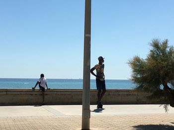 Father and son watching the skyline at sitges spain