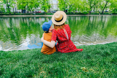 Rear view of woman with umbrella in lake