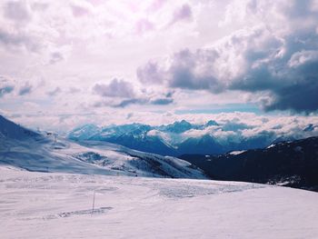 Scenic view of mountains against cloudy sky
