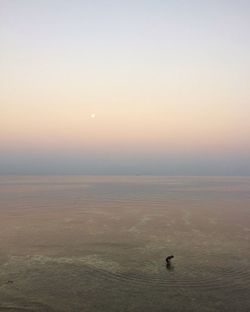 Scenic view of sea against sky at sunset