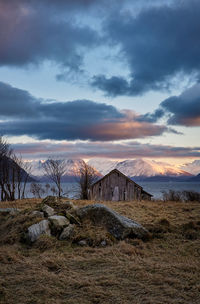 An old collapsing boathouse staring out over the sunnmørsalps, godøy, norway