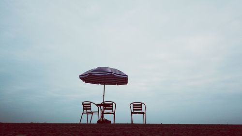 Low angle view of lifeguard hut on beach against sky