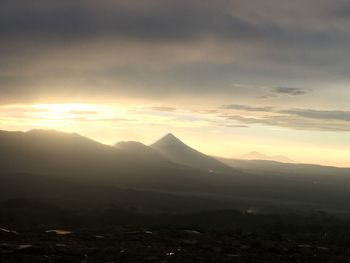 Scenic view of mountains against sky at sunset