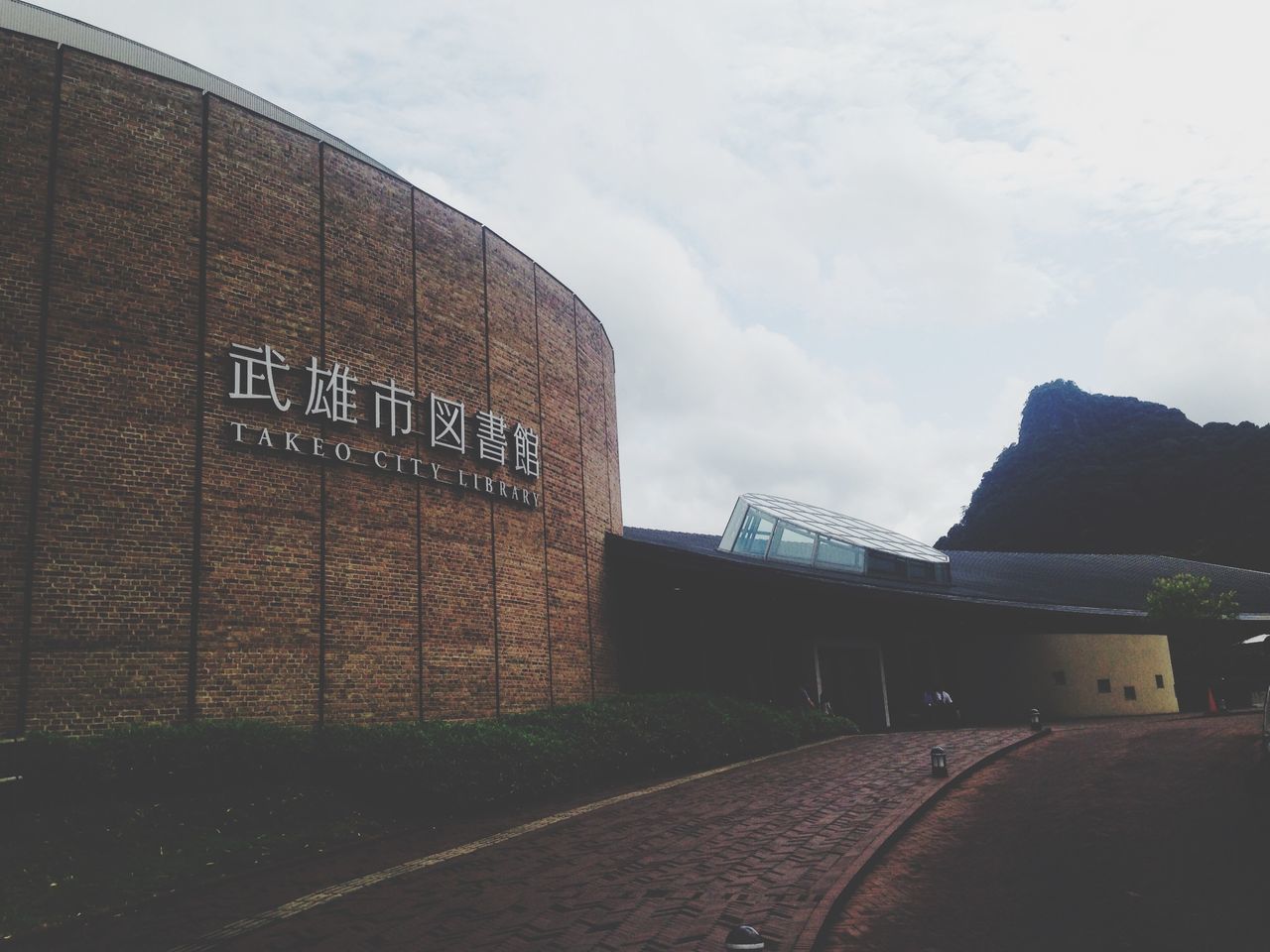 architecture, built structure, sky, the way forward, building exterior, transportation, road, diminishing perspective, cloud - sky, day, street, outdoors, empty, no people, wall - building feature, vanishing point, text, road marking, railing, cloud