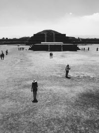 People standing on landscape against sky