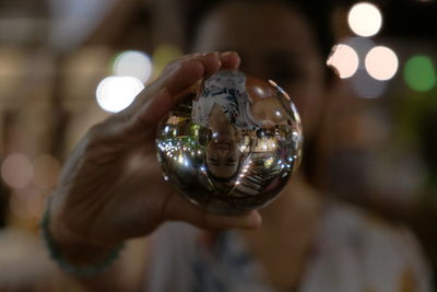 Close-up of woman holding crystal ball