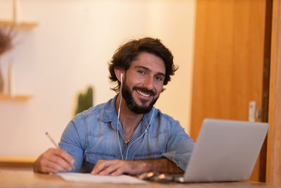 Young business man working with laptop. gray notebook for working. home office . 