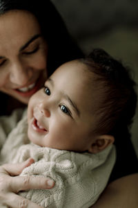 Mother with smiling male toddler at home