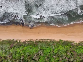 High angle view of rocks on sea shore