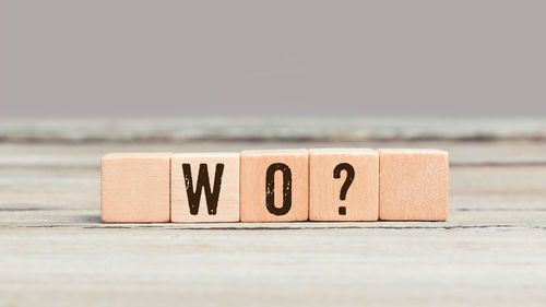 Close-up of text on wooden table