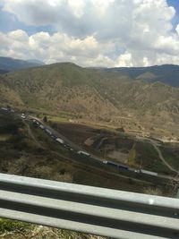 Scenic view of mountains against cloudy sky