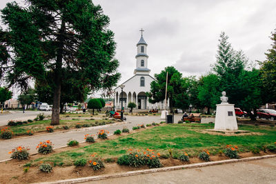 View of cemetery and building against sky