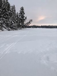 Scenic view of snow covered land against sky