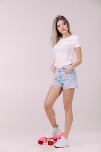 Young woman standing against white background