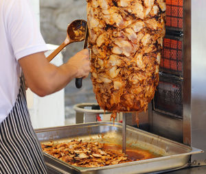 Man working on barbecue grill