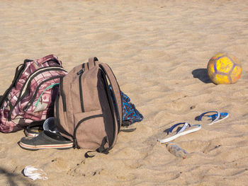 High angle view of shoes on sand at beach
