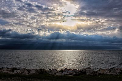 Scenic view of sea against storm clouds