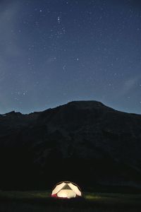 Tent on field against sky at night