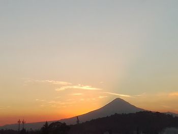 Scenic view of silhouette mountains against sky during sunset