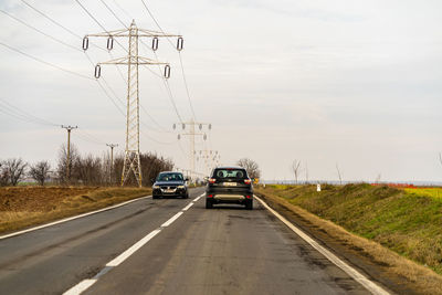 Cars on road against sky