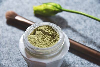 Close-up of ground herb in jar on table