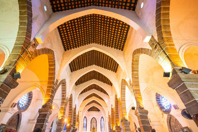 Low angle view of illuminated ceiling of historic building