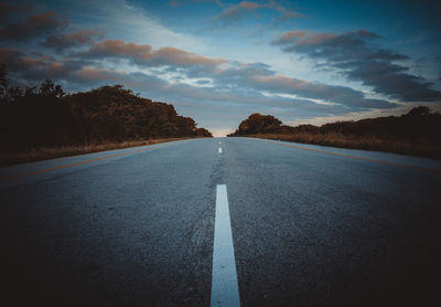 Highway against sky at sunset