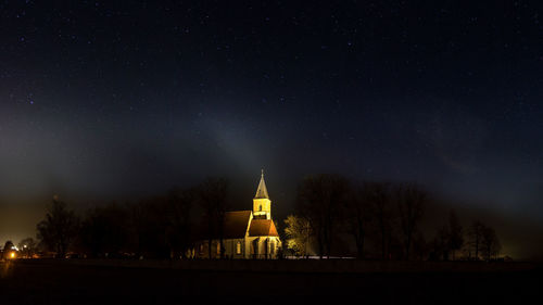 Illuminated cathedral against sky at night