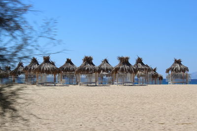 Built structure on beach against blue sky