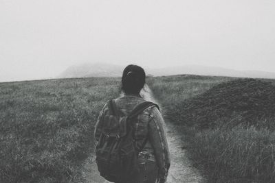 Rear view of man looking at field